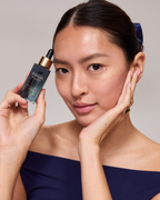 model posing with the vitamin c serum 