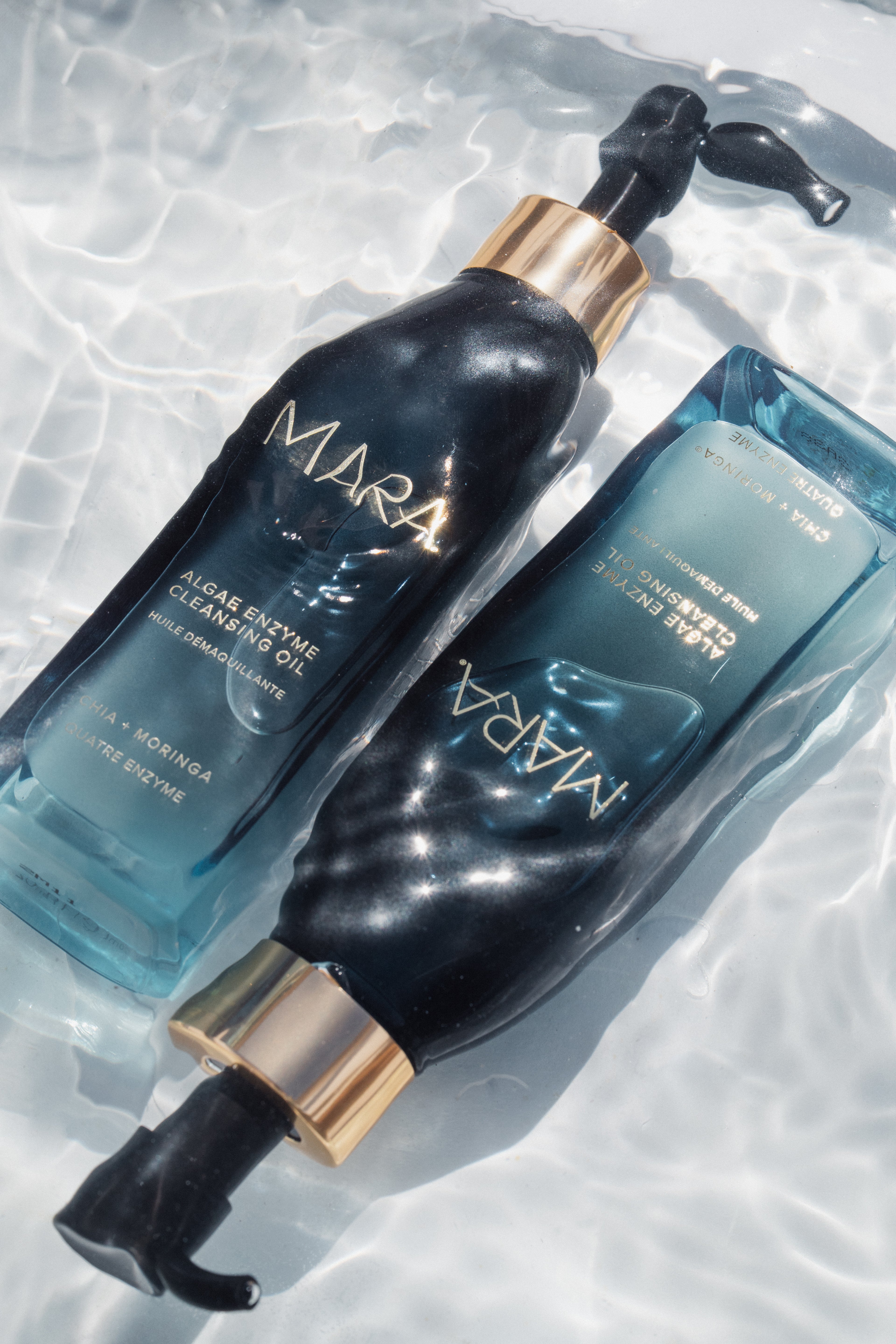 Two bottles of MARA skincare products on a textured white background