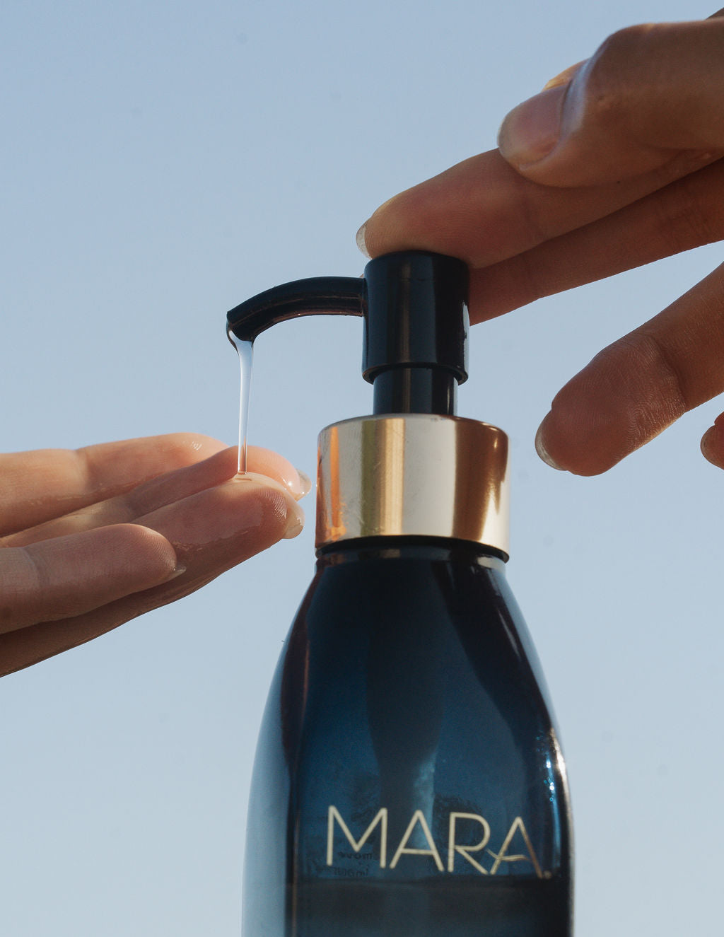 Hands pumping out algae enzyme cleansing oil