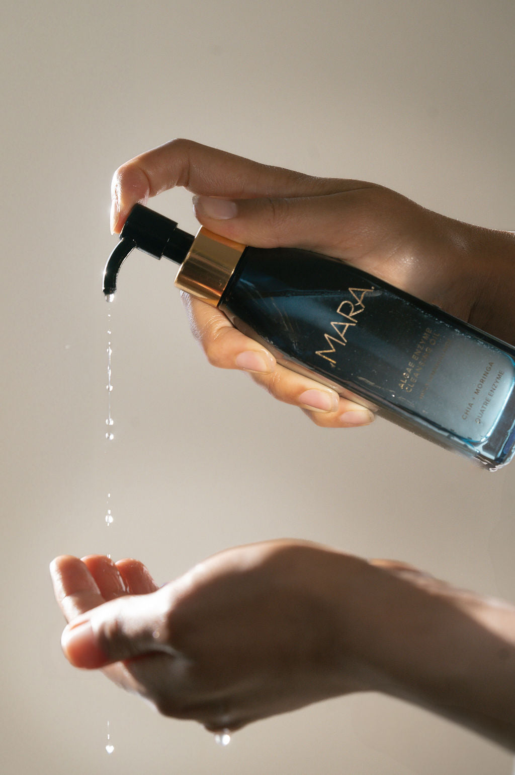 Algae Enzyme Cleansing Oil pumping onto palm of hand