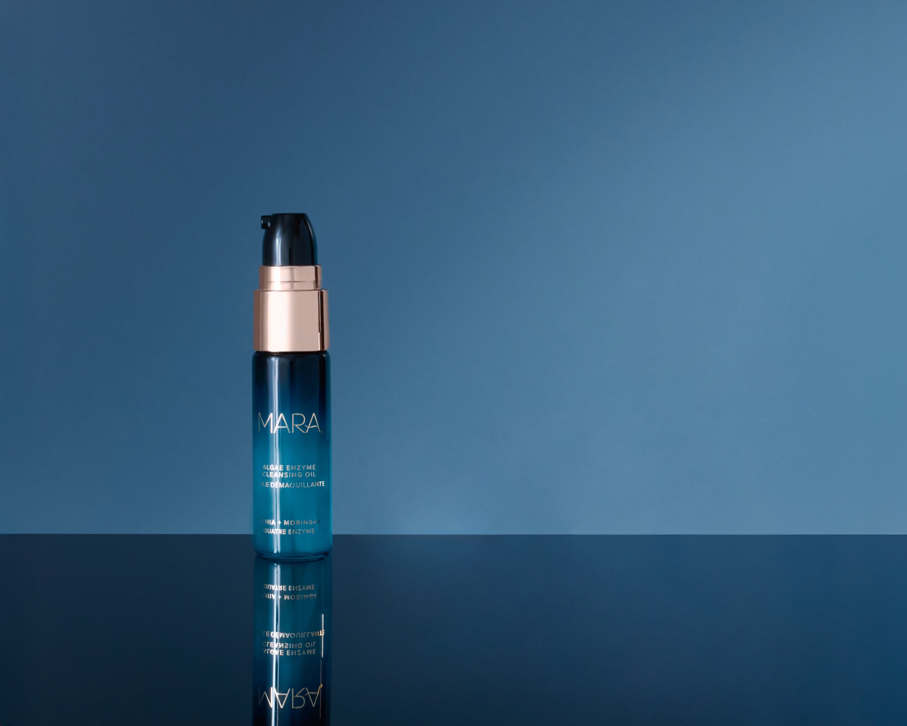 Deluxe+ Algae Enzyme Cleansing Oil on blue background
