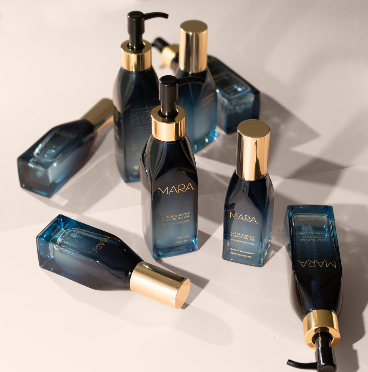 Full size and Mini Algae Enzyme Cleansing Oil in front of mirror