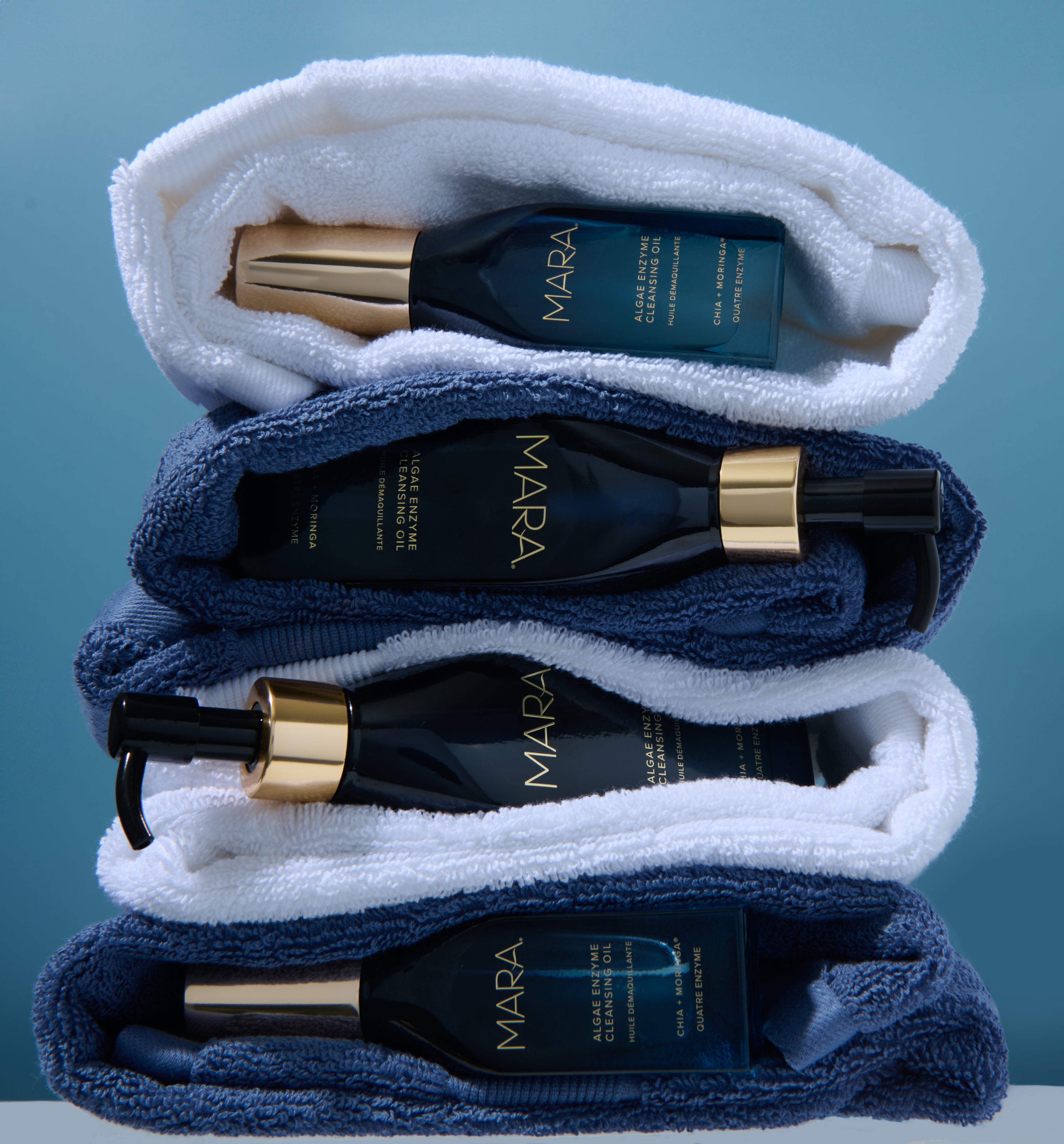 Algae Enzyme Cleansing Oil with mini size and folded in between towels