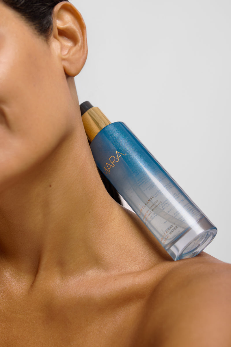 Models shoulder and collarbone with aura cleanser on it