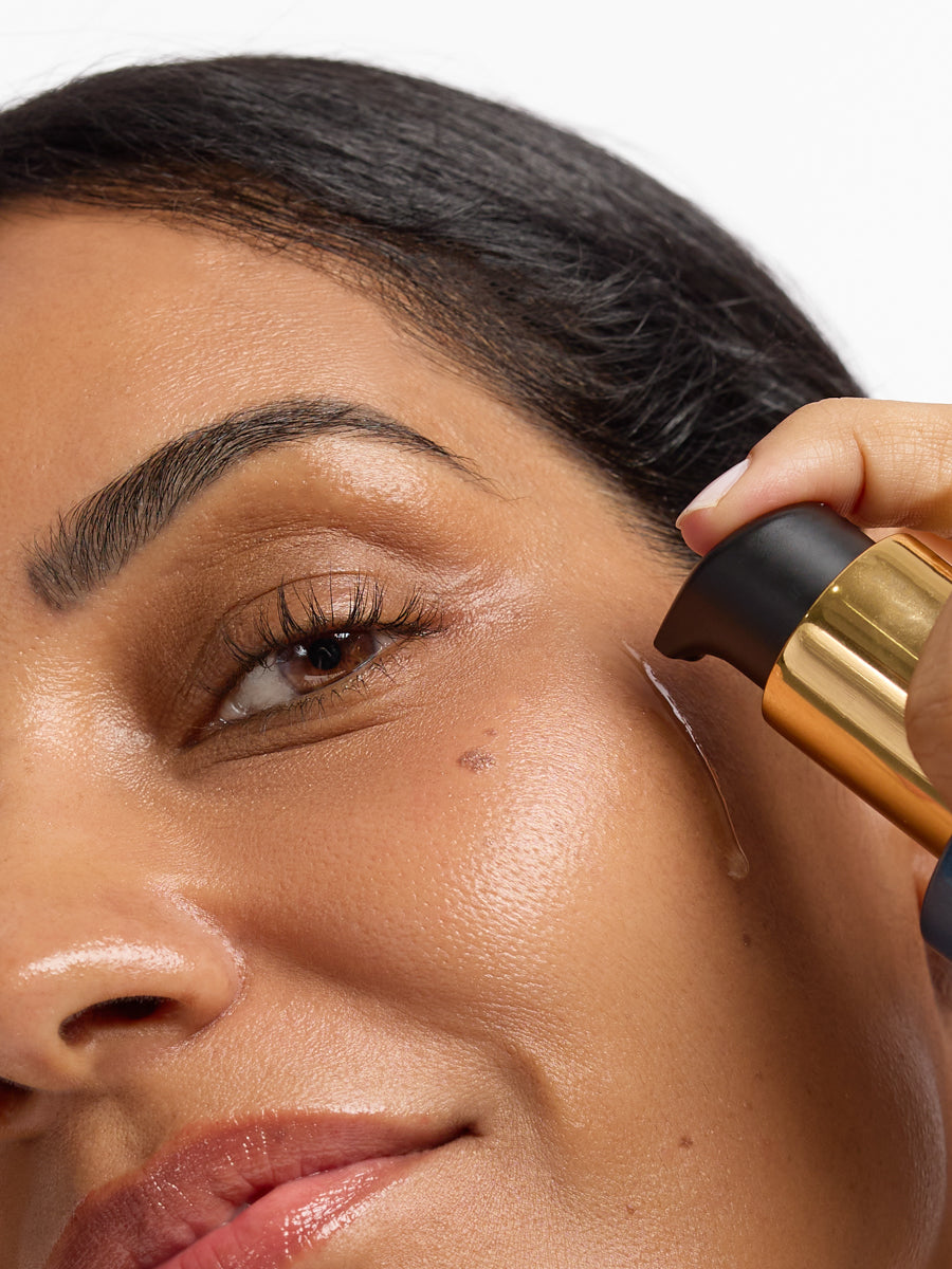 Person applying Aura Cleanse Foaming Gel Cleanser to face