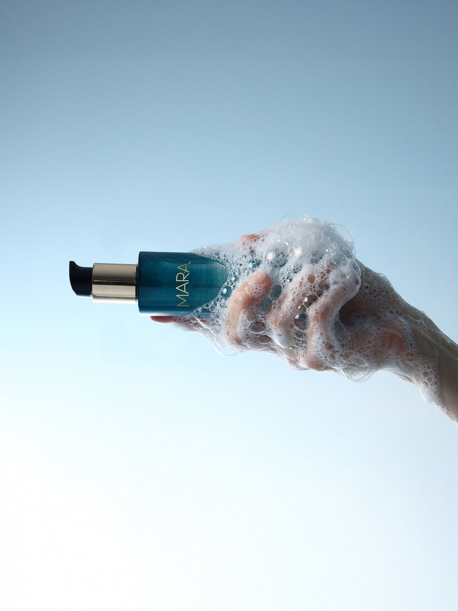 hand holding foamy Aura Cleanse Foaming Gel Cleanser