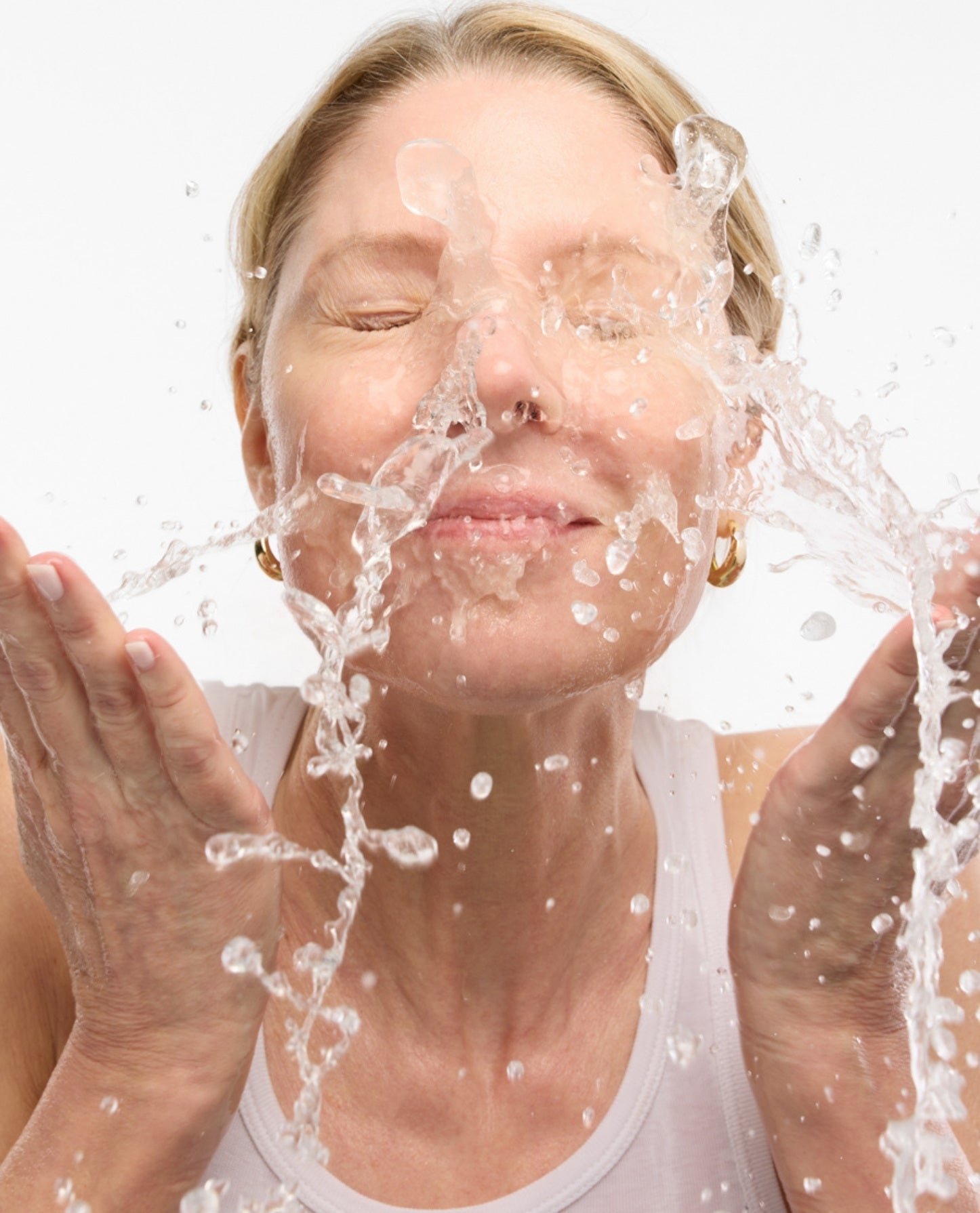 woman splashing her face with water