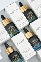 mulitple Universal Face Oil and boxes laying together