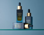 Three bottles of Algae Retinol Face Oil on a blue background
