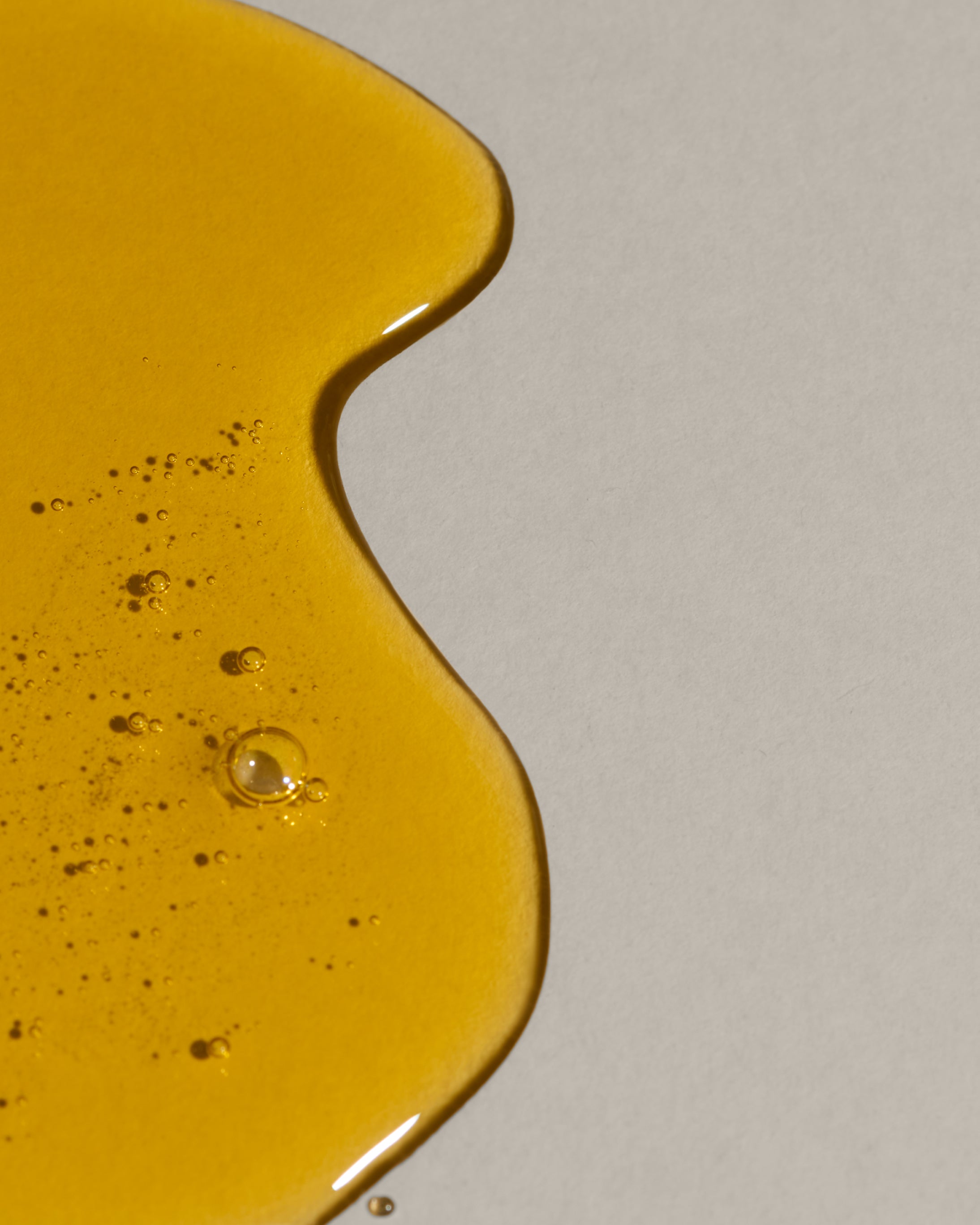 swatch of Algae Retinol Face Oil on beige background