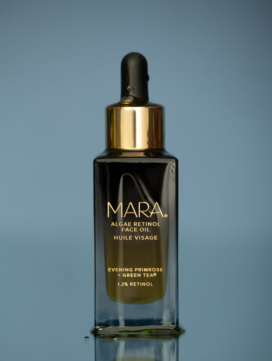 MARA Algae Retinol Face Oil on blue background with oil dripping