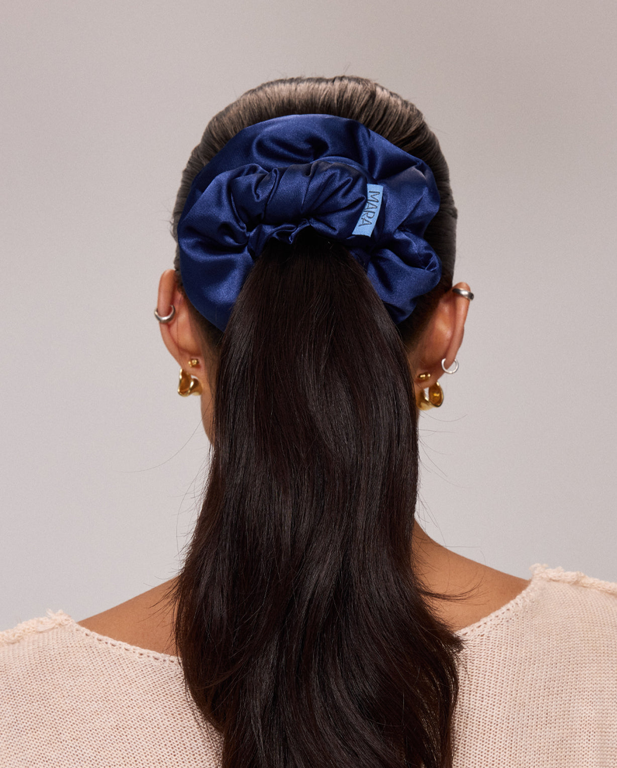 person with ponytail using MARA Navy Silk Scrunchie