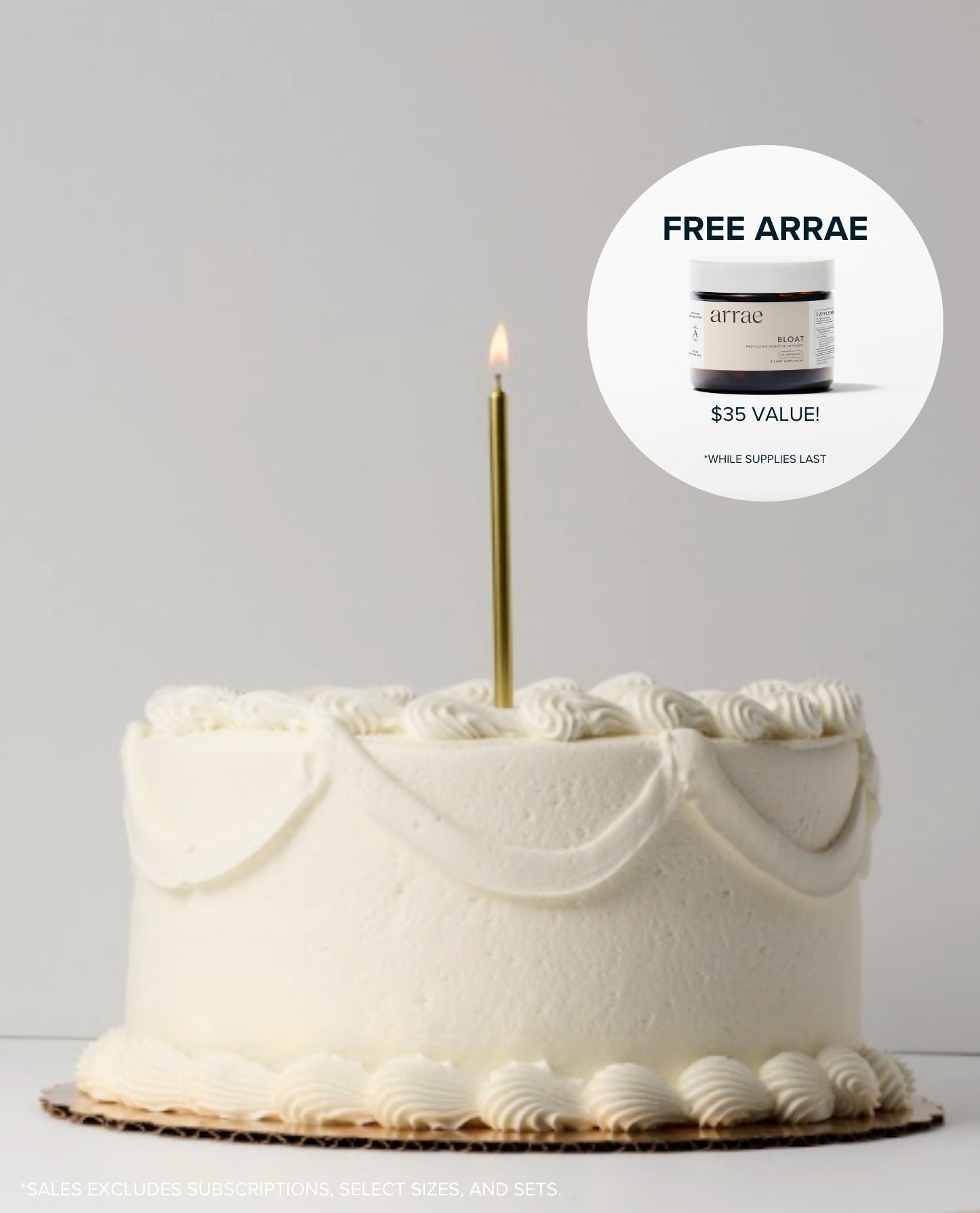 White cake with a lit candle on a gray background, featuring a free product offer.
