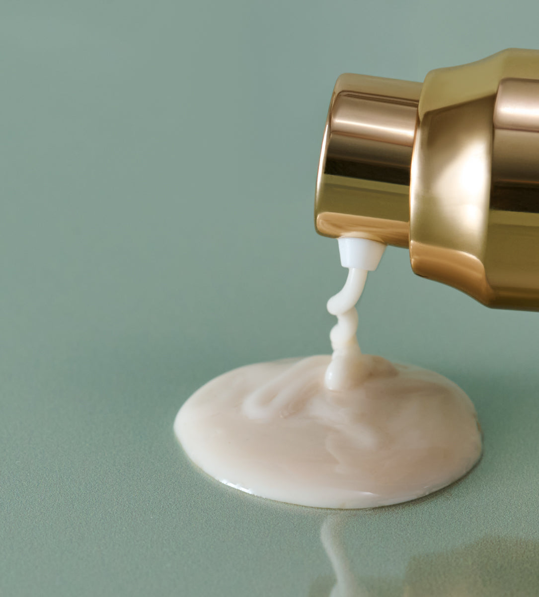 Clear Skin Mineral Milk dispensed on green surface