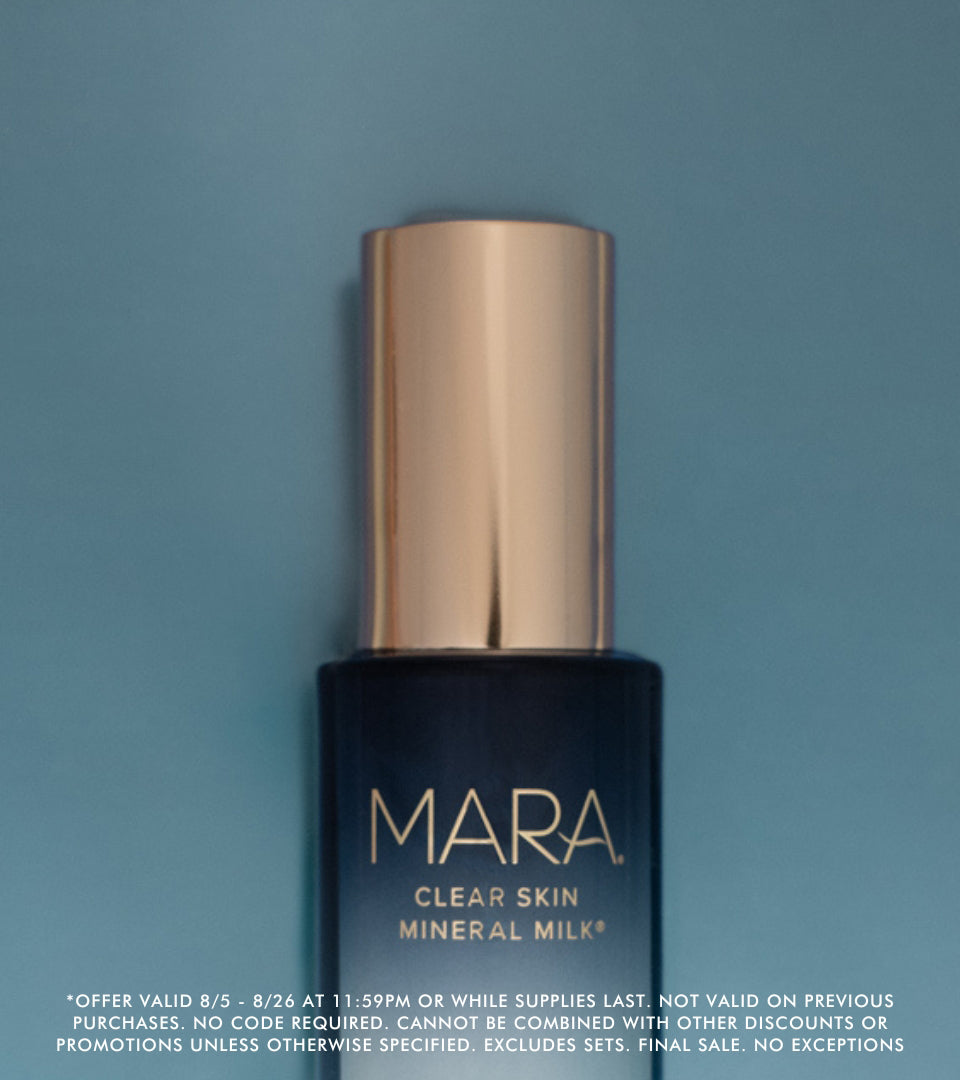 Clear Skin Mineral Milk bottle on a blue background