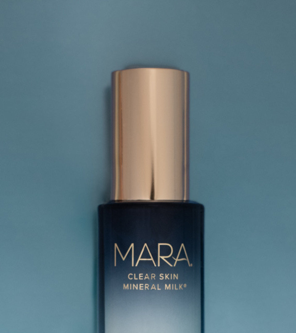 Clear Skin Mineral Milk bottle on a blue background