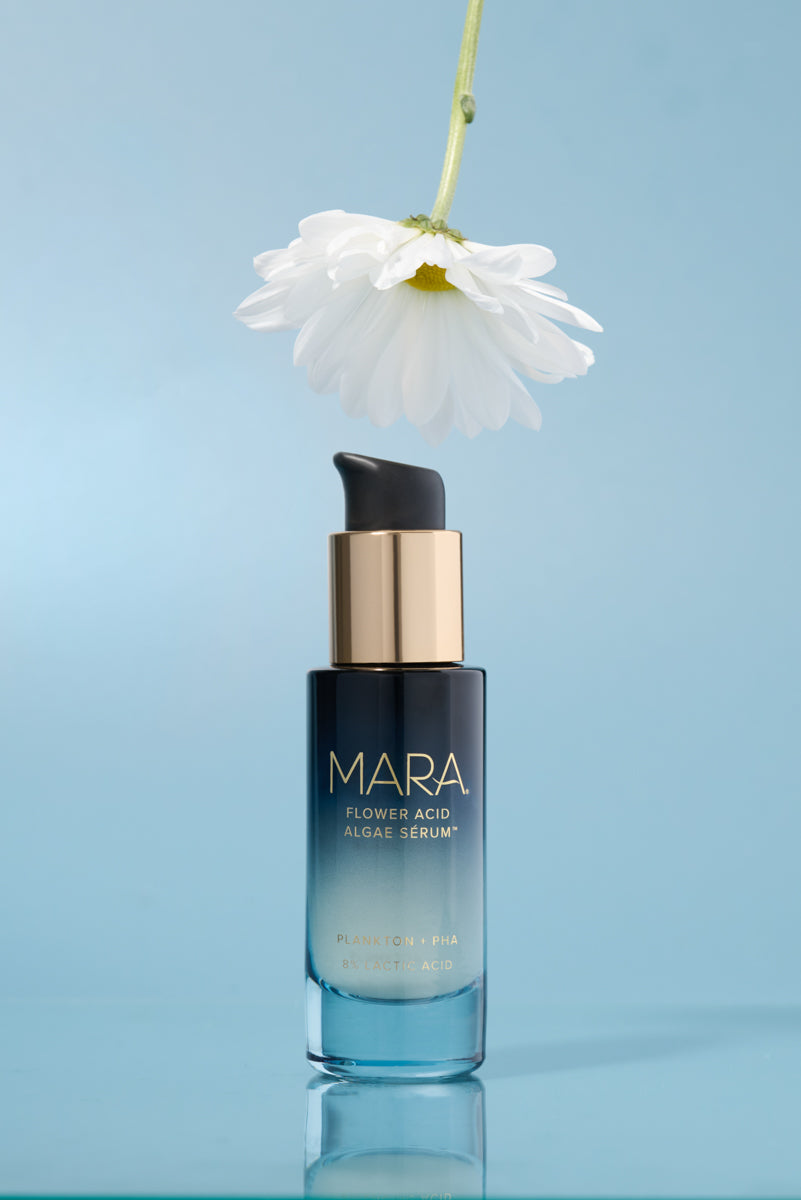Flower Acid Algae Serum  with a white flower on a light blue background