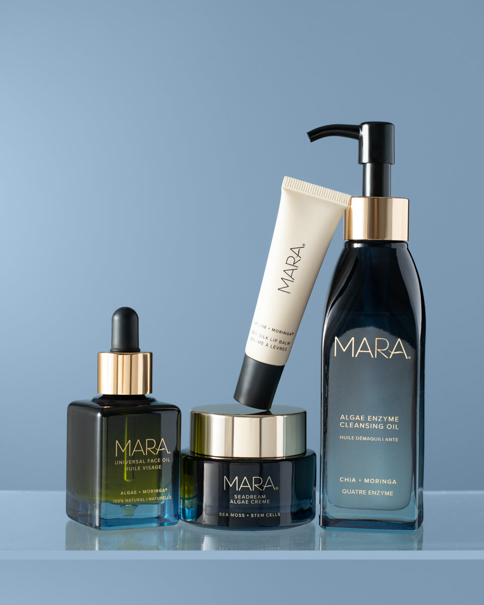 MARA Universal Oil, SeaDream, Lip Balm, and Cleansing Oil on a blue background