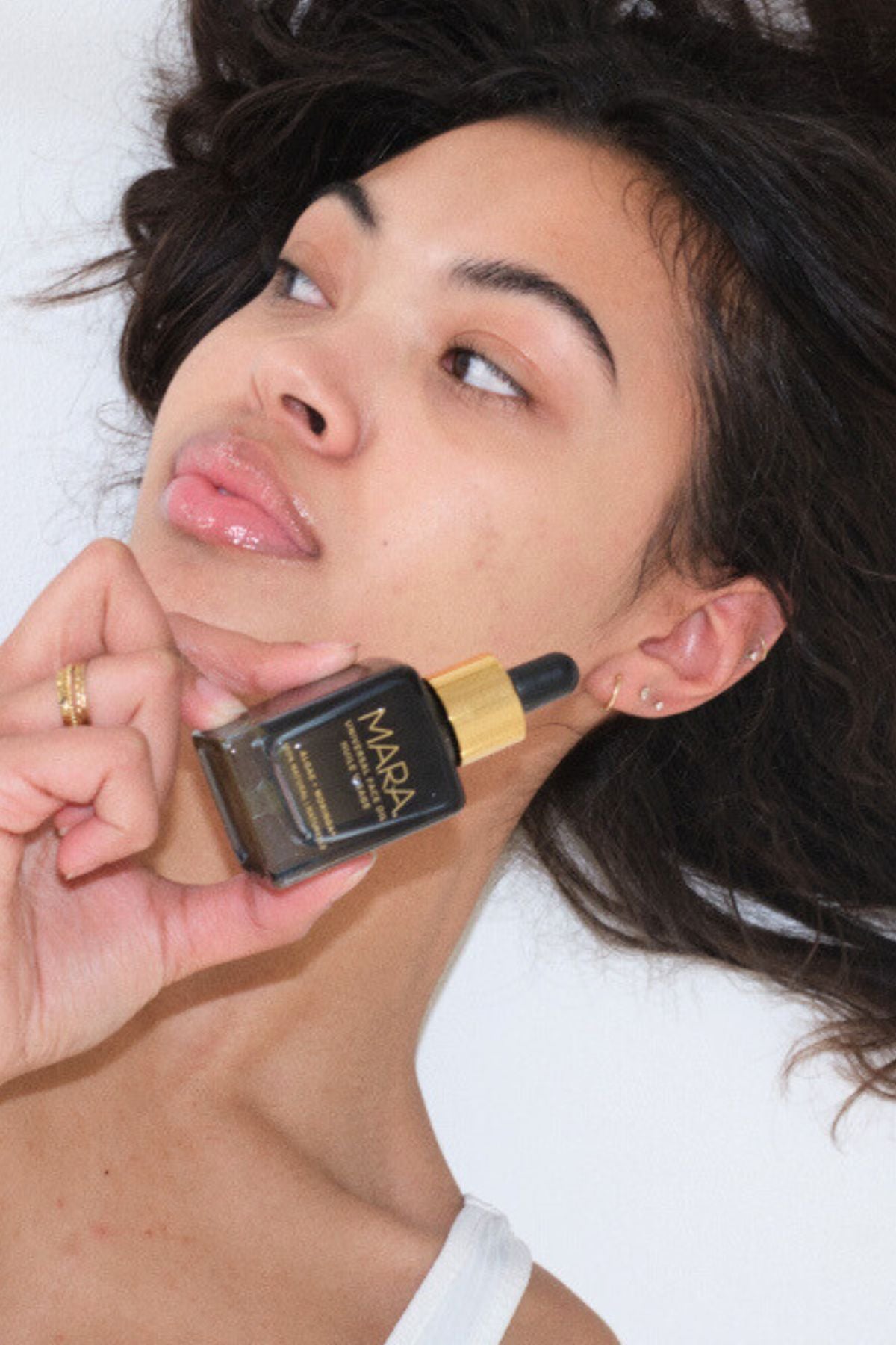 Model holding Unviersal Face Oil