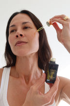 Model applying Algae Retinol Face Oil