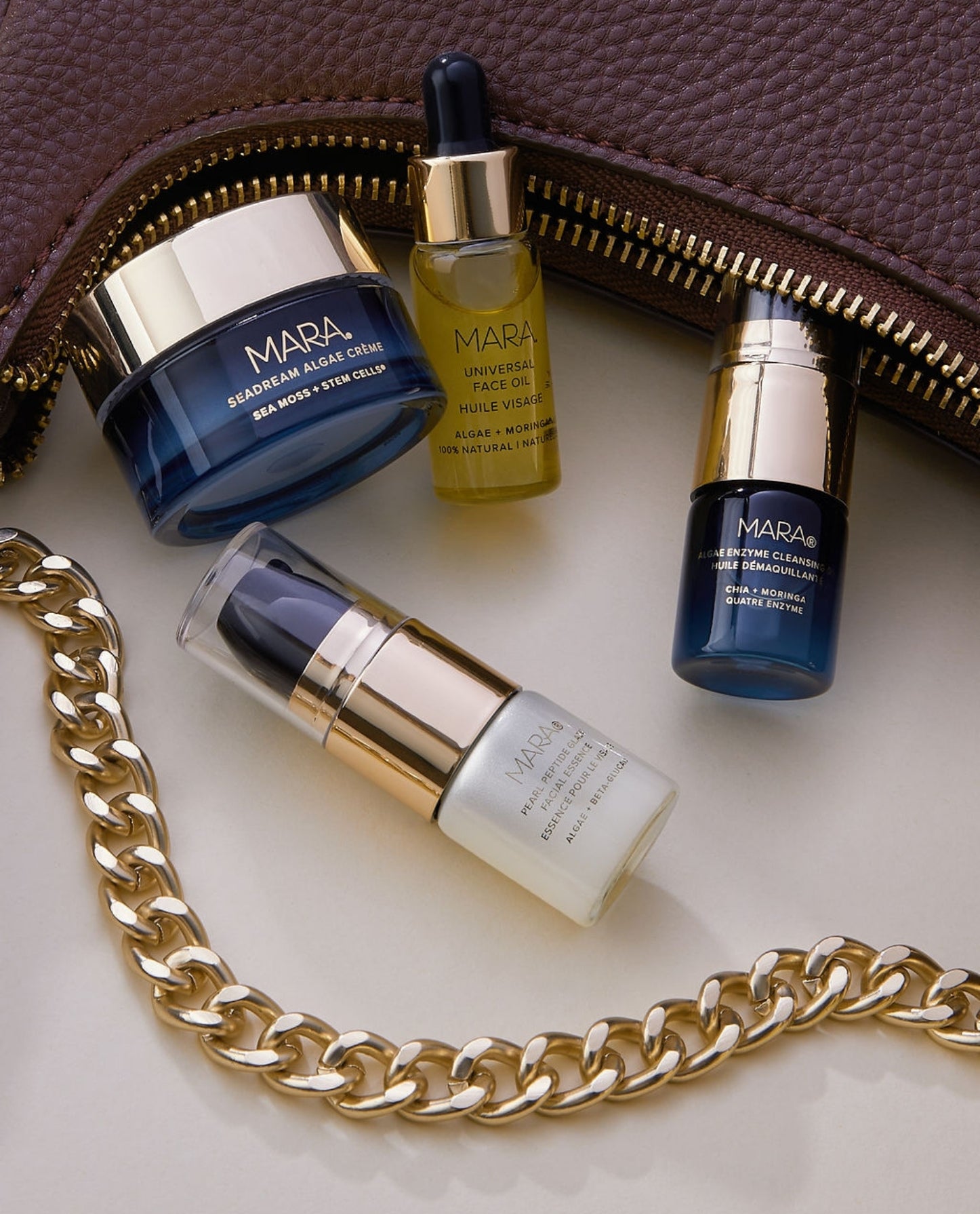 Intro Deluxe Kit spilling out of burgundy purse with gold chain