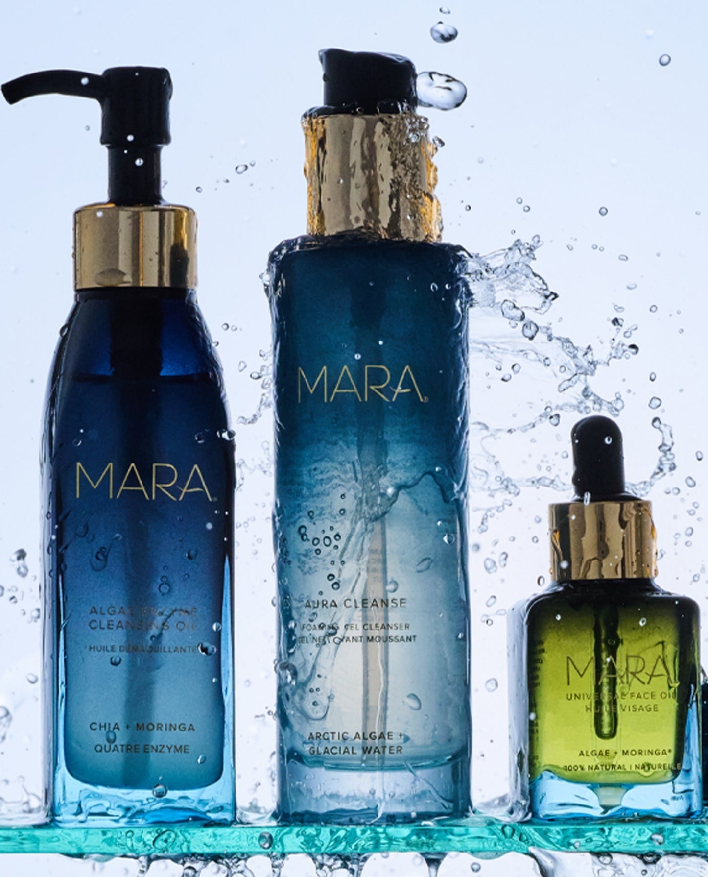 Algae Enzyme, Aura Cleanse, and Universal Oil on glass shelf with water splashing