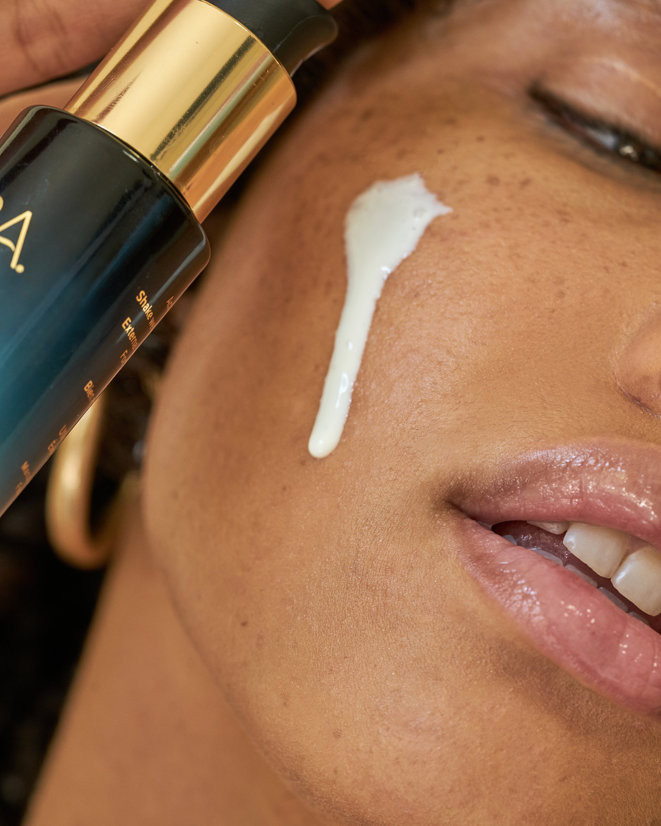 Close up of MARA Sea Kale Sunscreen on woman's face