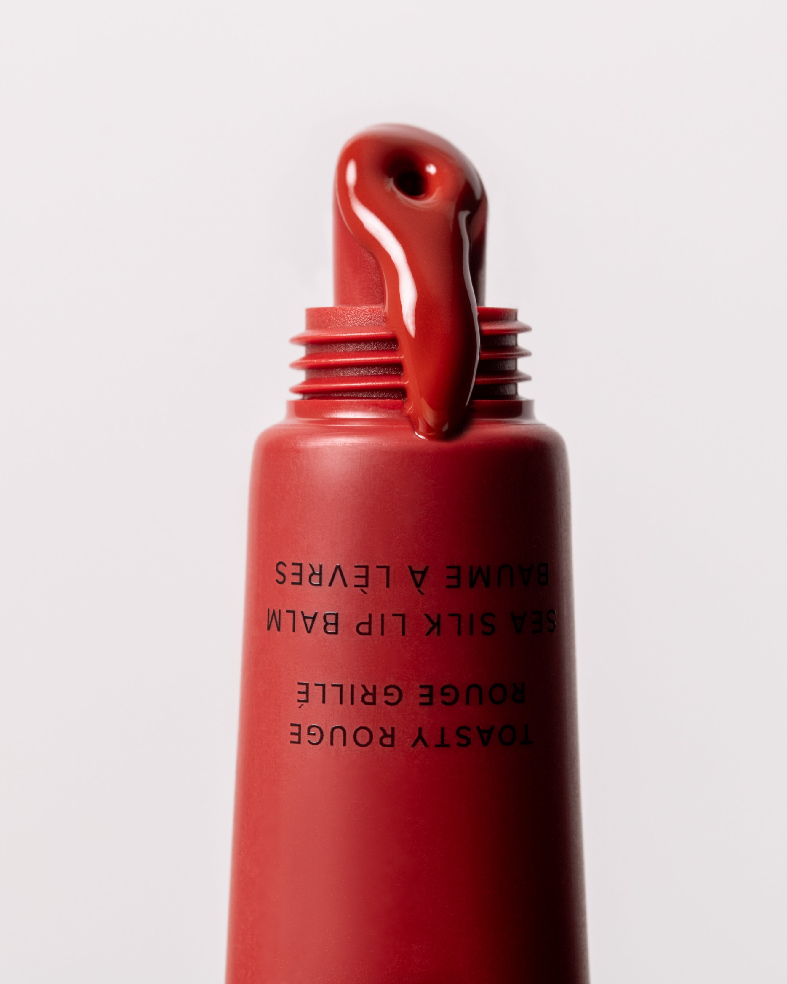 Close up of MARA Sea Silk Lip Balm Toasty Rouge product 