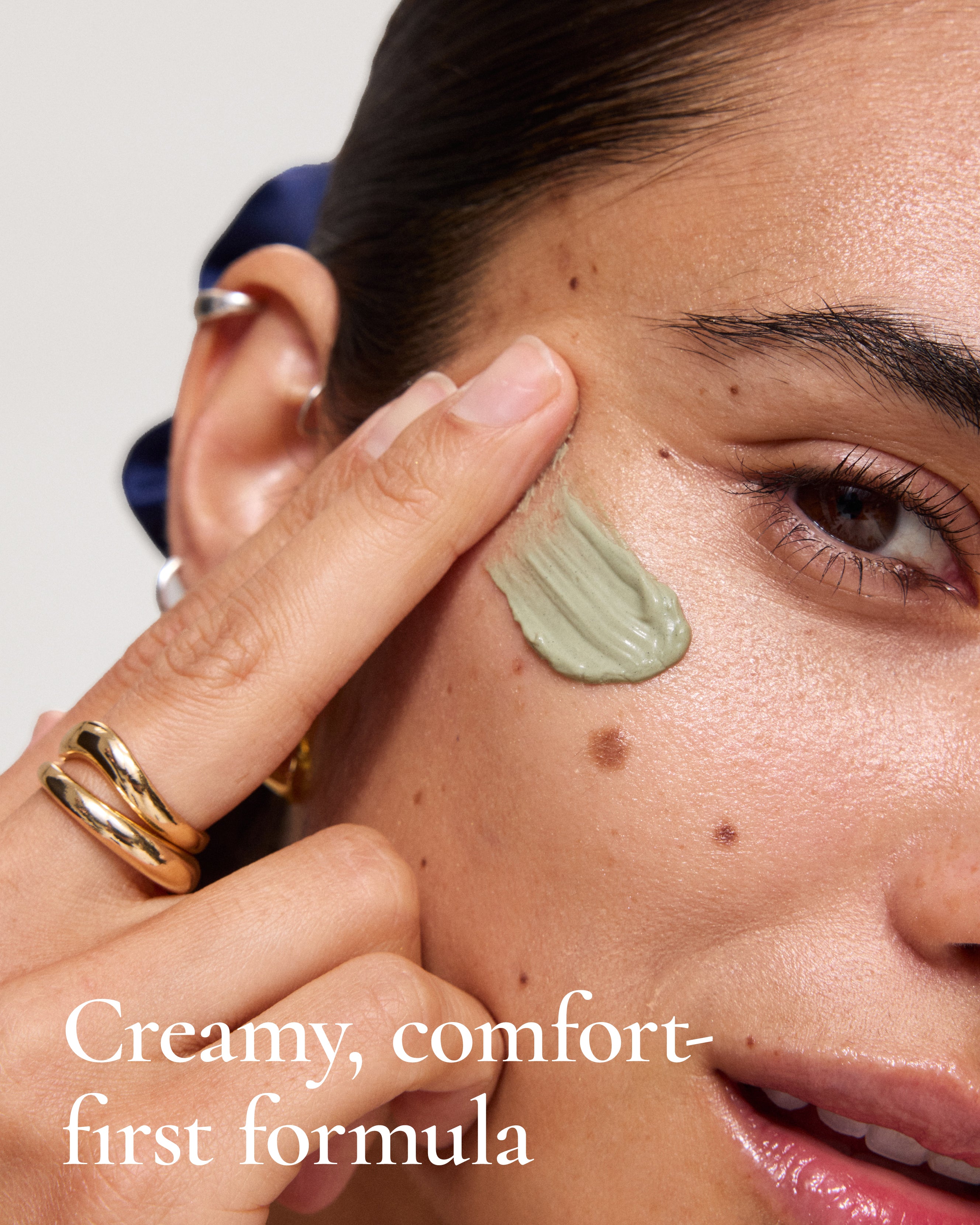 Swatch of MARA Volcanic Sea Clay Detox Masque on woman's face