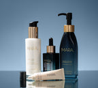 Cleansing Oil, Pearl Peptide, Vitamin C, and Lip Balm on a blue gradient background