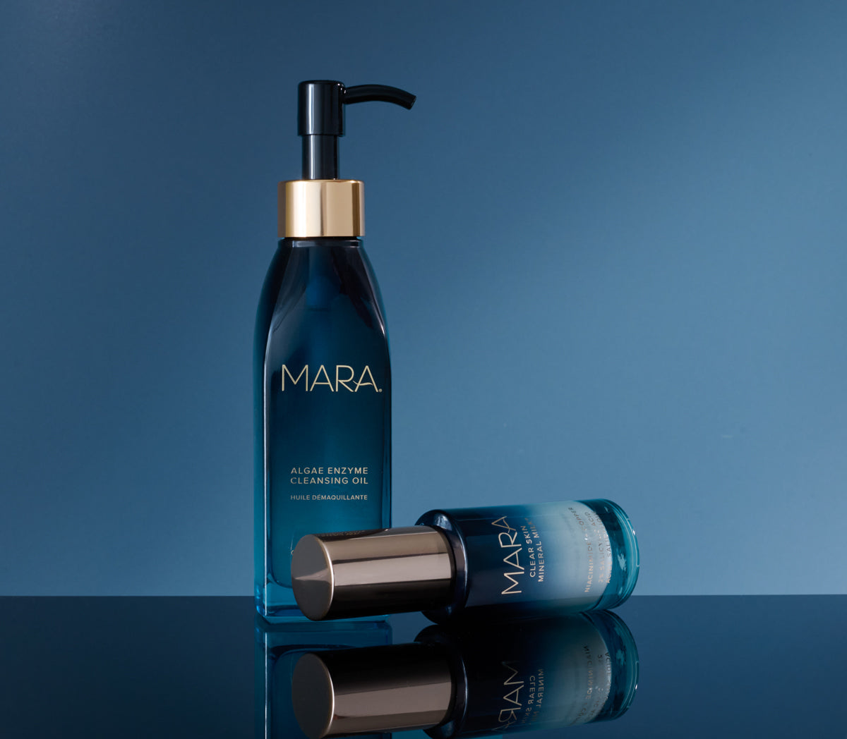 Cleansing Oil and Clear Skin Mineral Milk on a blue background