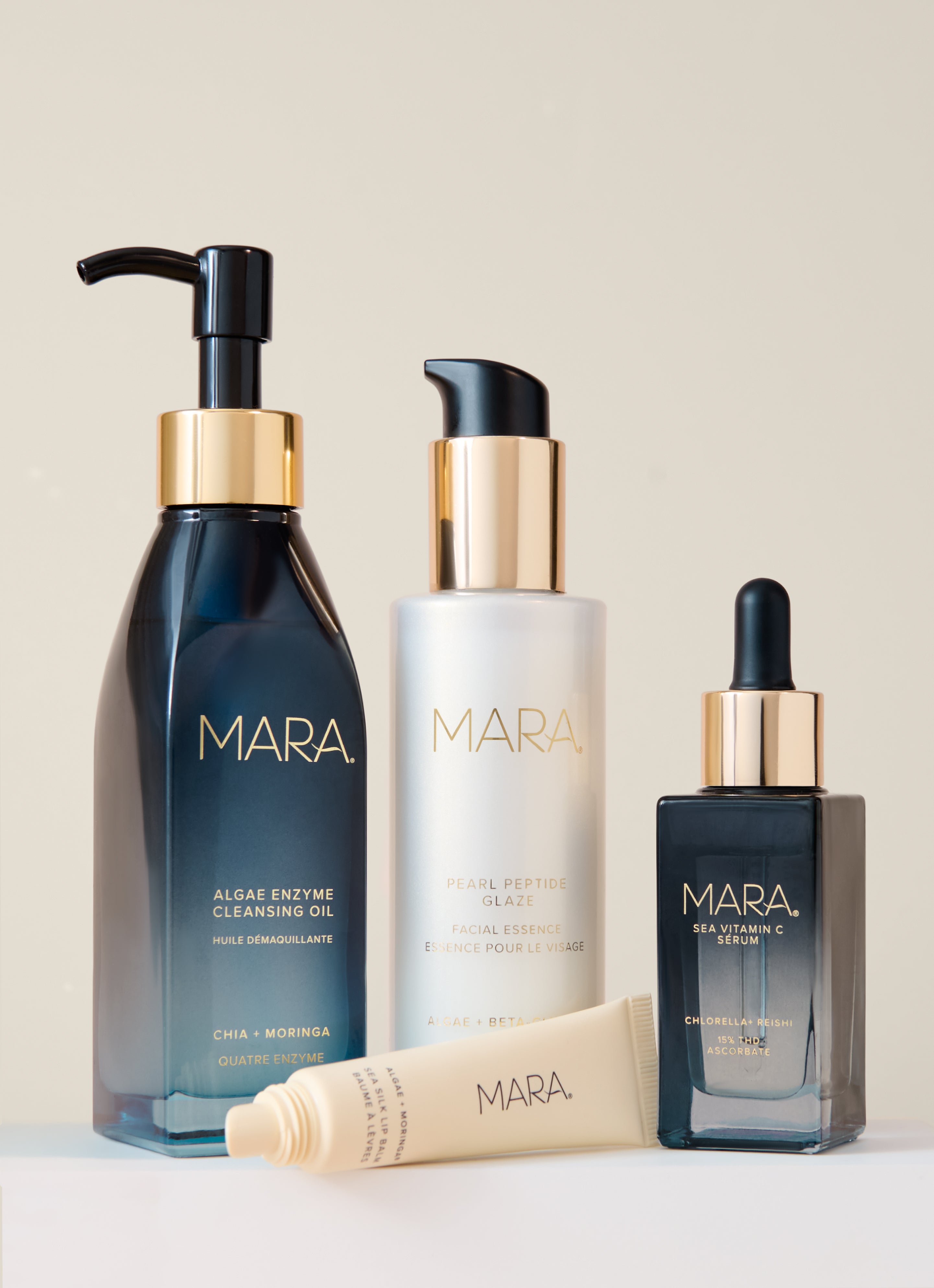 Cleansing Oil, Pearl Peptide, Lip Balm, and Vitamin C on beige background