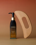 Sea Sculpt Body Oil and Body Tool on gradient orange background