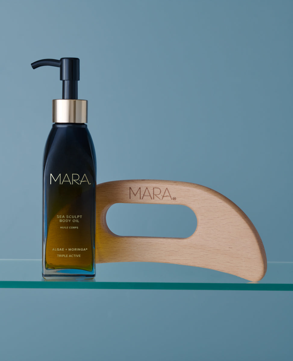 Sea Sculpt Body Oil and Body Tool on shelf on blue background