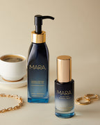 Cleansing Oil and Clear Skin Mineral Milk on a beige surface with a cup of coffee and gold jewelry
