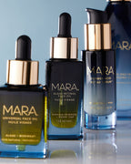 Universal Oil, Retinol Oil, Flower Acid, and Cleansing Oill on light blue