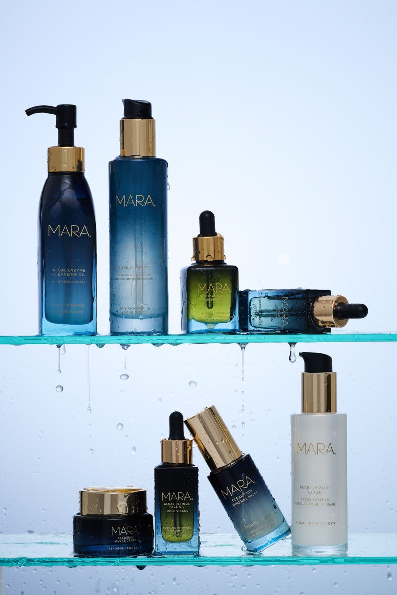Collection of Mara skincare products on a glass shelf with a light blue background