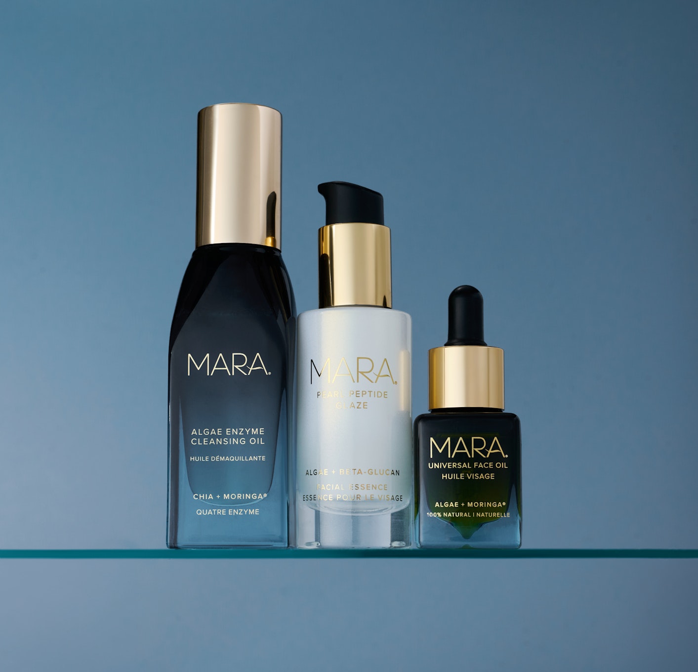 Travel Essentials Trio on glass shelf with blue background