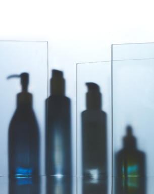 Algae Enzyme Cleansing Oil, Aura Cleanse Gel Cleanser, Pearl Peptide Glaze, Universal Face Oil behind glass panels