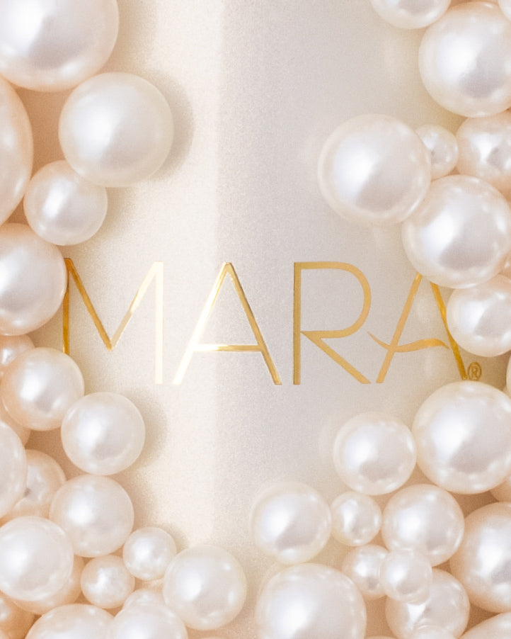 close up of Pearl Peptide Glaze surrounded by pearls