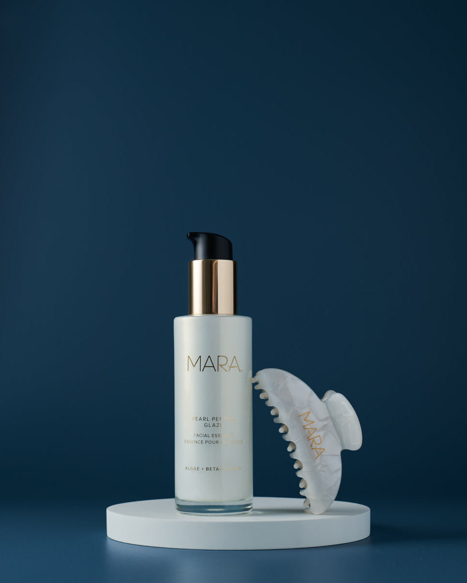 Pearl Peptide Glaze with Hair Claw on a dark blue background