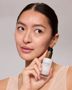 Woman holding a Mini Pearl Peptide Glaze with a neutral background