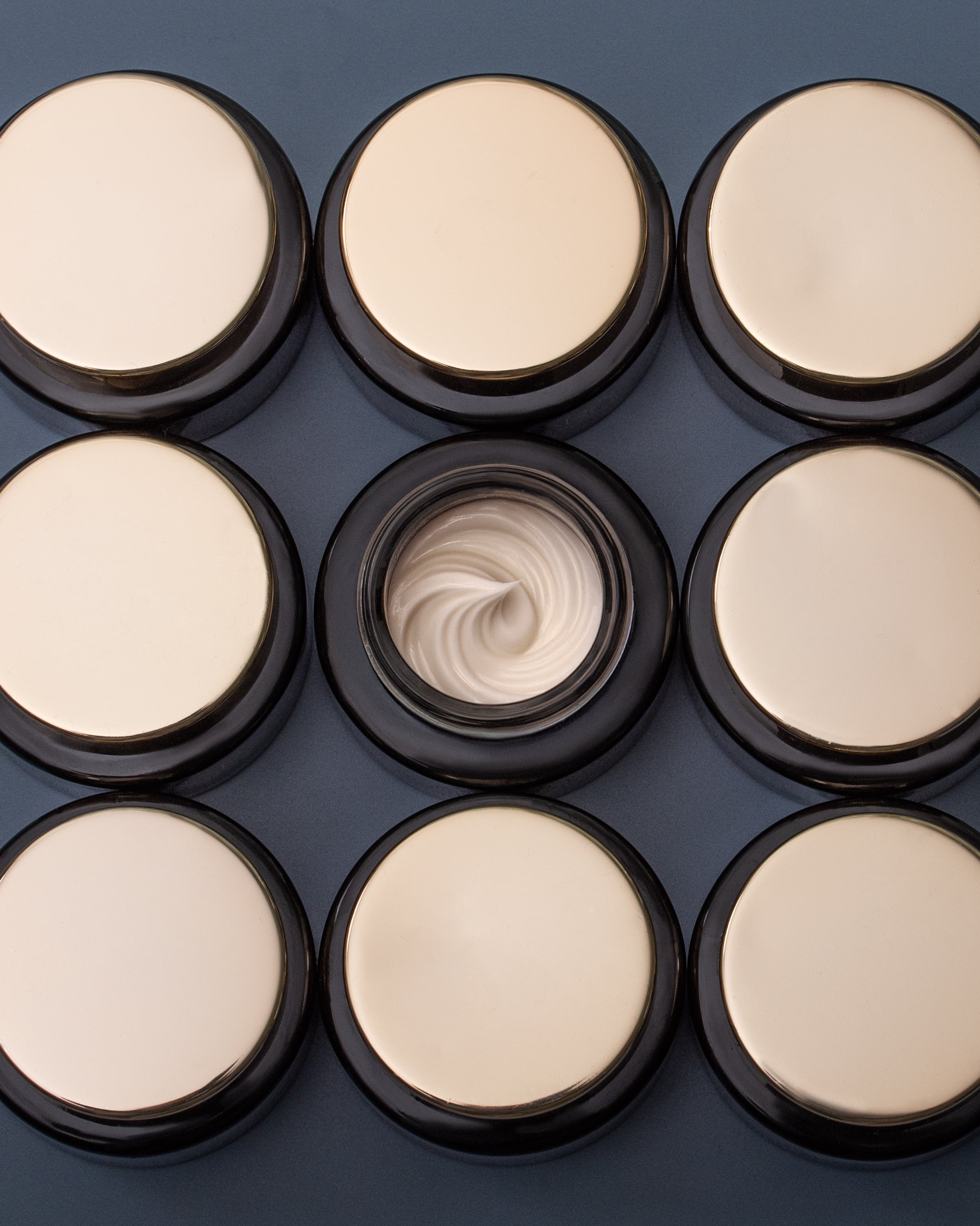 Multiple jars of SeaDream Algae Creme with a focus on one jar showing a swatch on a dark background