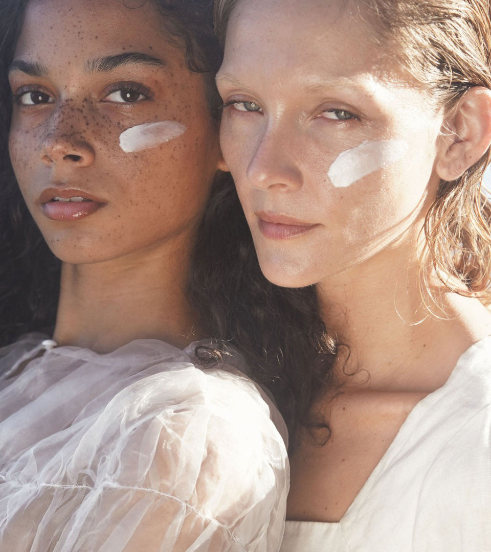 Two people with SeaDream Algae Creme swatch on cheekbones