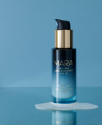 Sea Kale Sunscreen Serum on top of texutre on blue surface