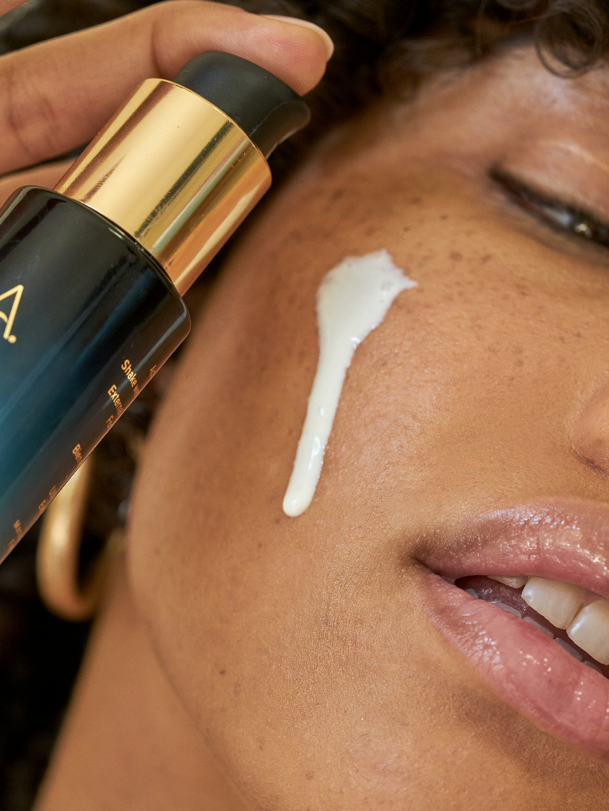 Close-up of a person applying Sea Kale Sunscreen Serum