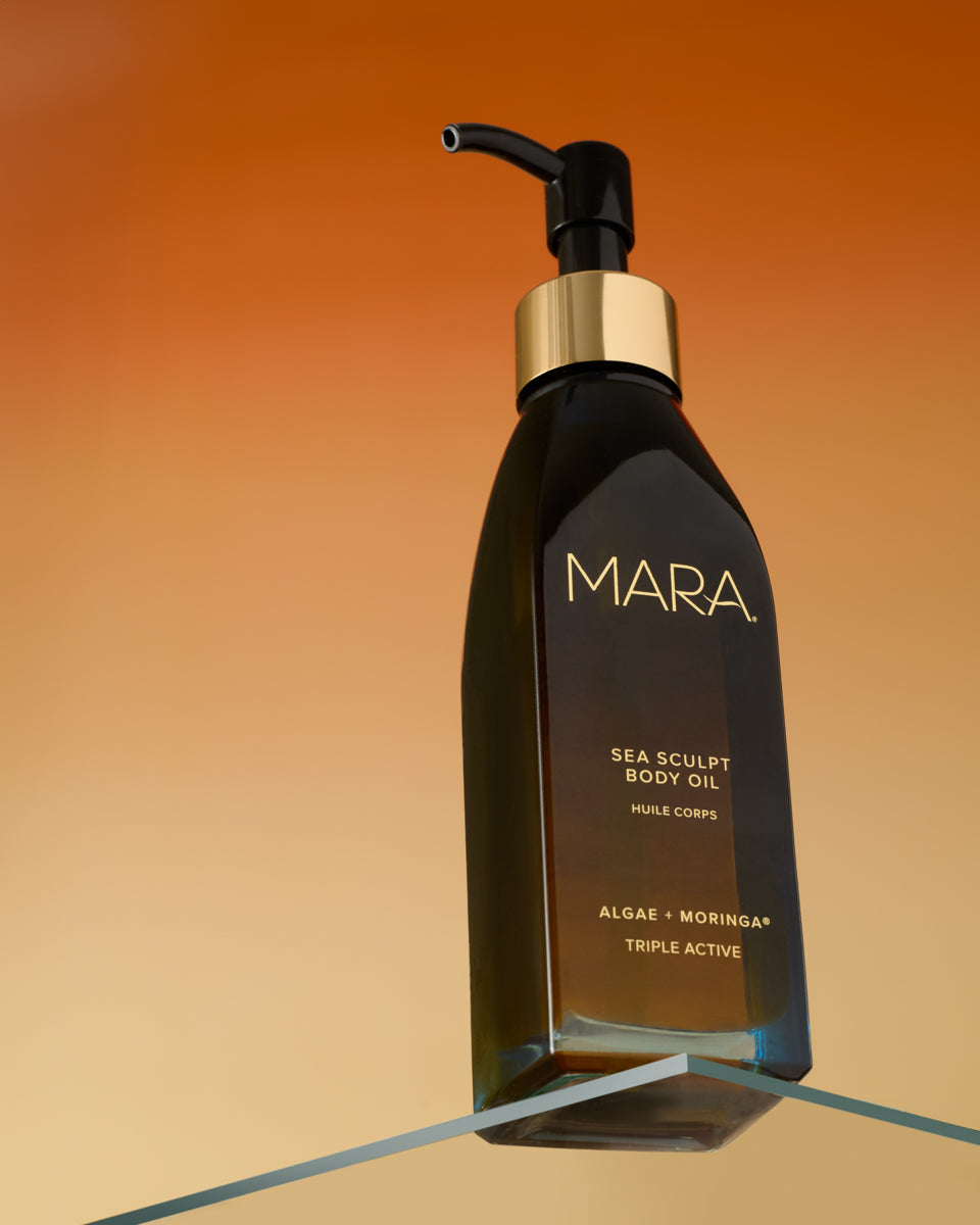 Mara Sea Sculpt Body Oil bottle on a gradient orange and brown background