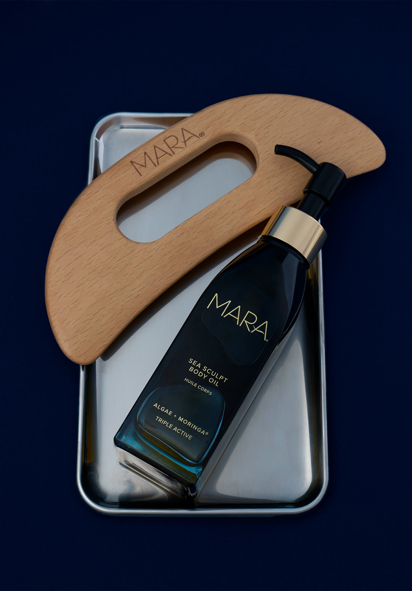 Sea Sculpt Body Oil and tool on silver tray