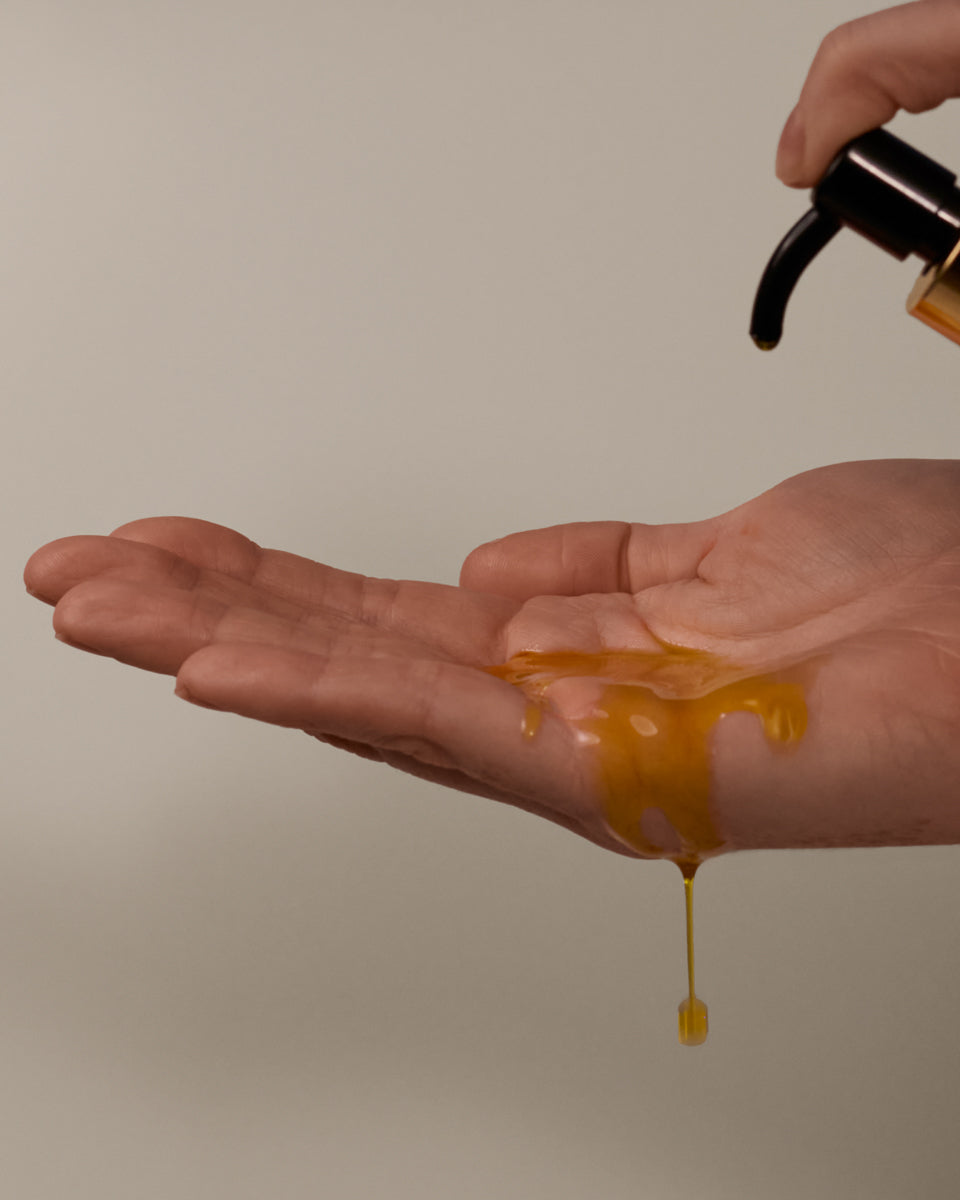 Hand applying Sea Sculpt Body Oil