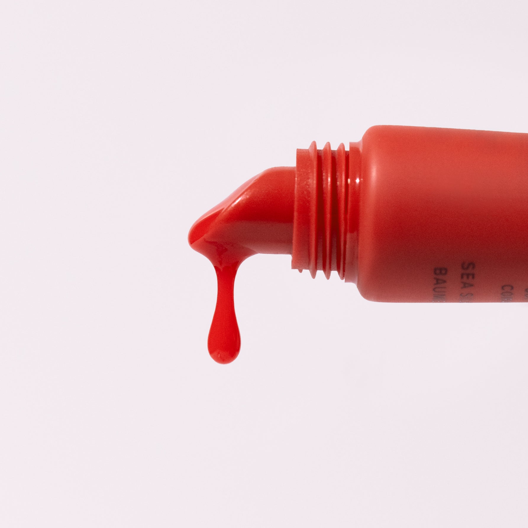 Soft Coral Sea Silk Lip Balm dripping out of applicator